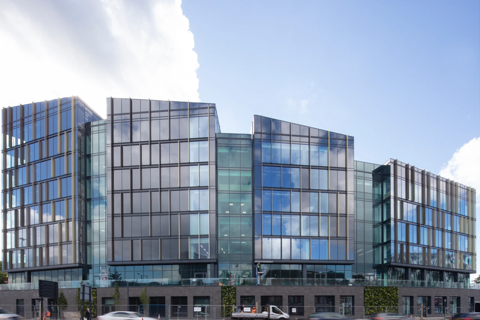 A large glass covered building with four distinct sections