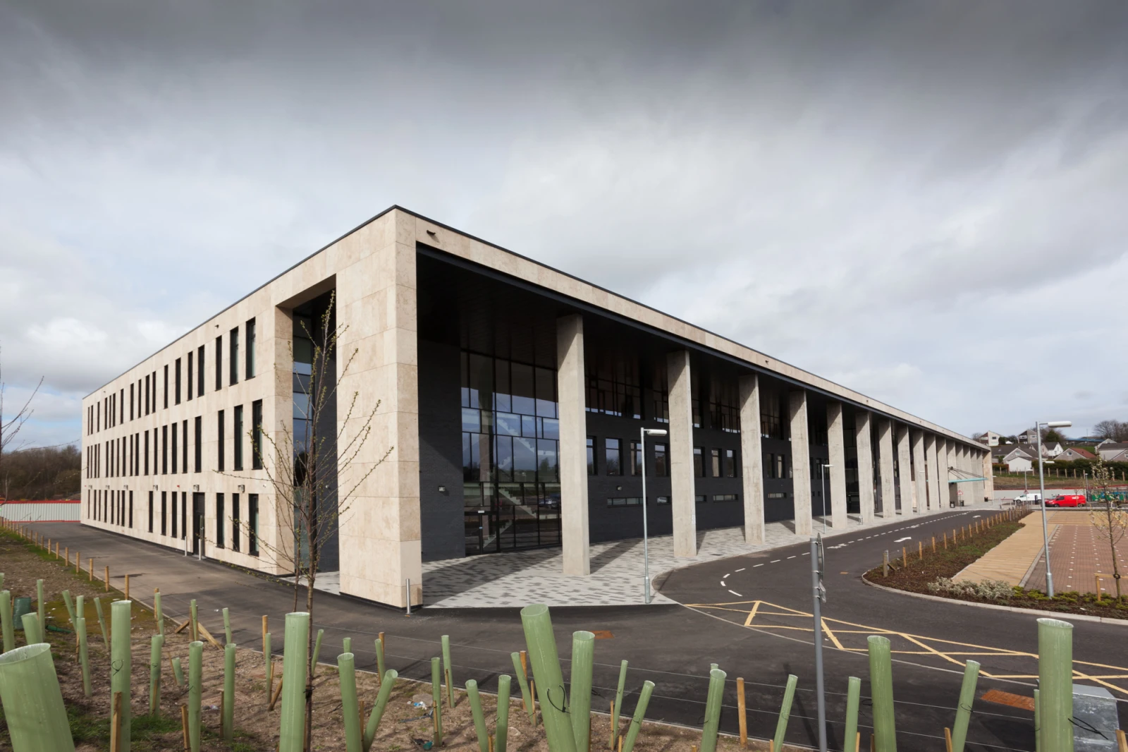 A large rectangular concrete building with pillars along its side